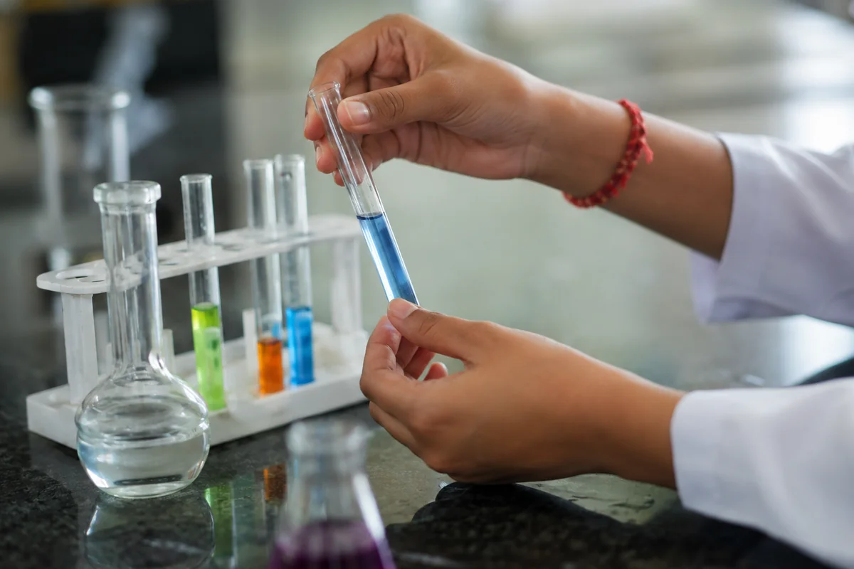 Chemistry practical with test tubes at Grow Up Coaching Centre, Burari